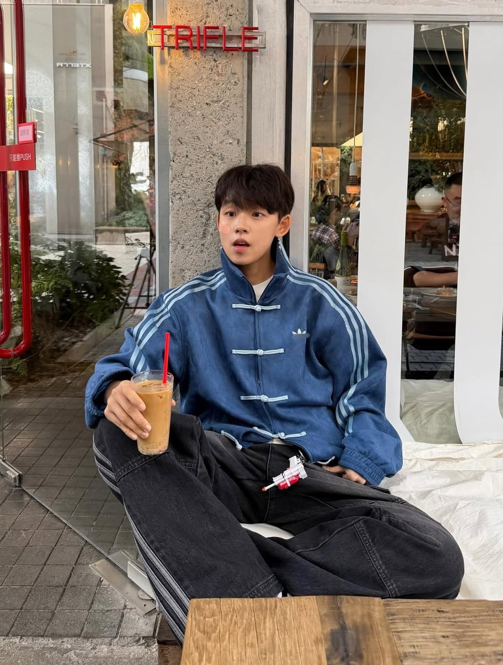 Blue Adidas Chinese New Year Tang jacket with three stripes worn at cafe - Streetbred streetwear collection