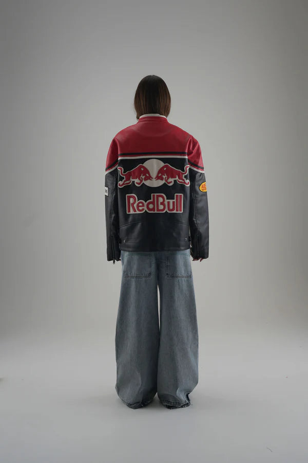 Person wearing a Red Bull jacket on a gray background
