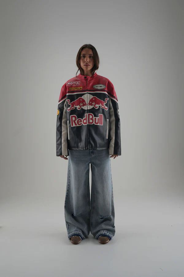 Person wearing a Red Bull jacket on a plain background