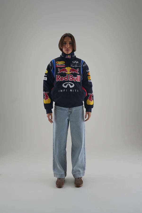 Person wearing a Red Bull Infiniti sweater on a gray background