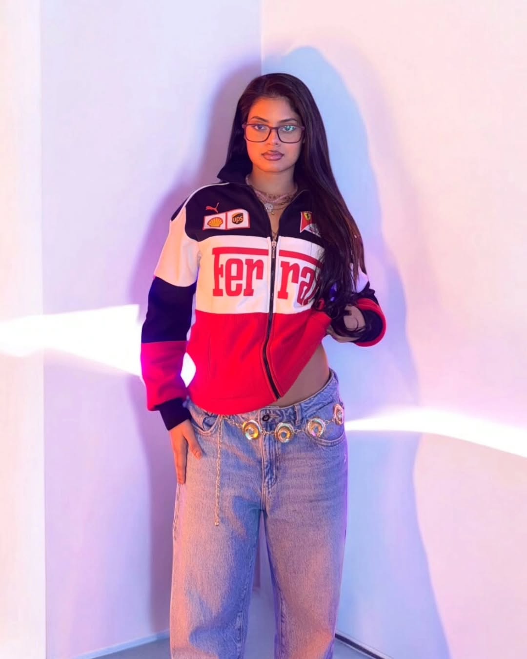 Person wearing a colorful jacket with Ferrari branding against a white background