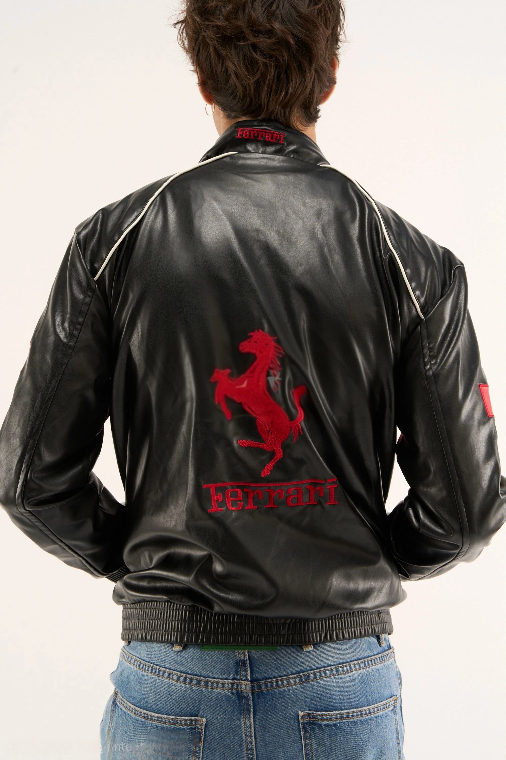 Back view of the Black Ferrari F1 Leather Jacket by Streetbred, displaying the large, high-density embroidered Scuderia Ferrari prancing horse logo.
