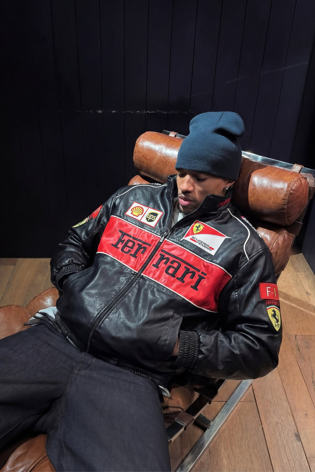 Streetwear styling of the Black Ferrari F1 Leather Jacket by Streetbred, featuring a premium faux leather frame and elastic cuffs.