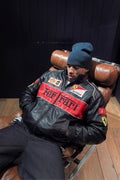 Streetwear styling of the Black Ferrari F1 Leather Jacket by Streetbred, featuring a premium faux leather frame and elastic cuffs.