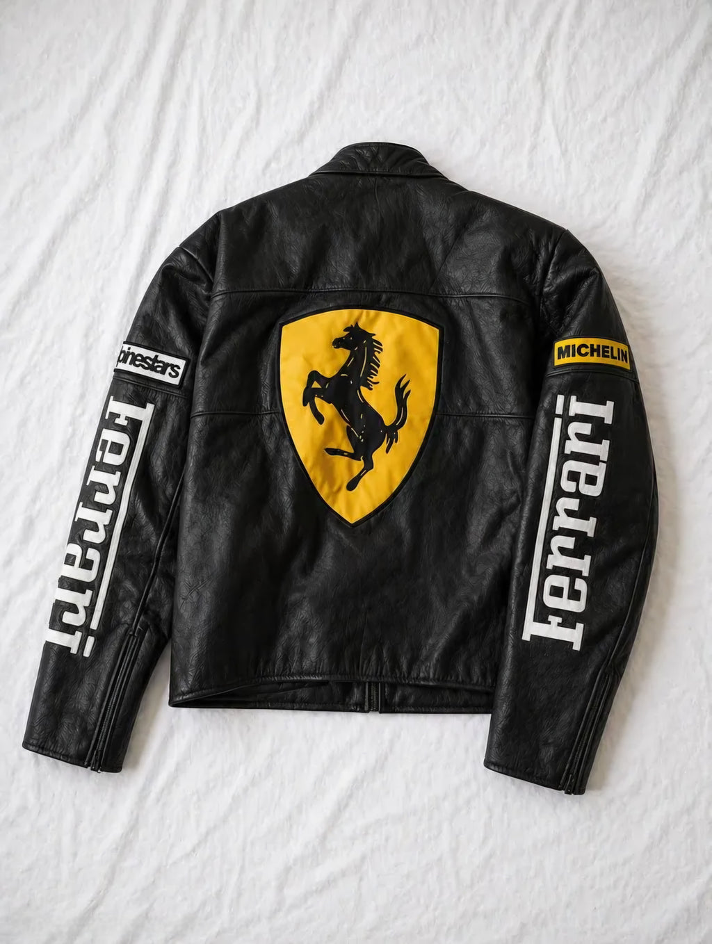 Back mockup view of the Black Ferrari Synthetic Leather Jacket by Streetbred, displaying the large embroidered Scuderia Ferrari prancing horse logo.