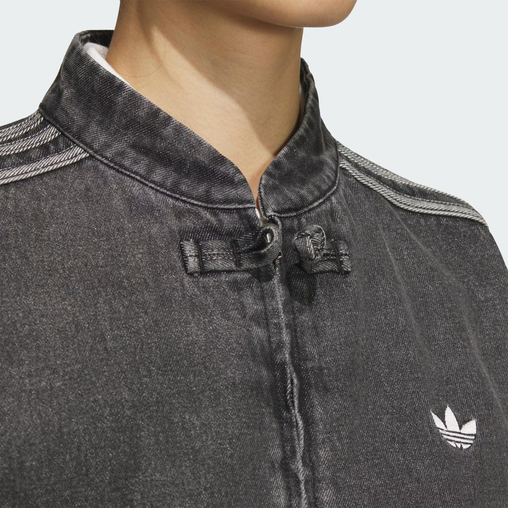 Close up detail of traditional Chinese knot closures on the oversized denim jacket
