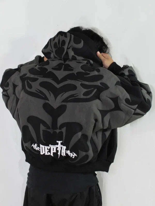 Person wearing a black hoodie with abstract designs and 'DEPTN' branding on the back.