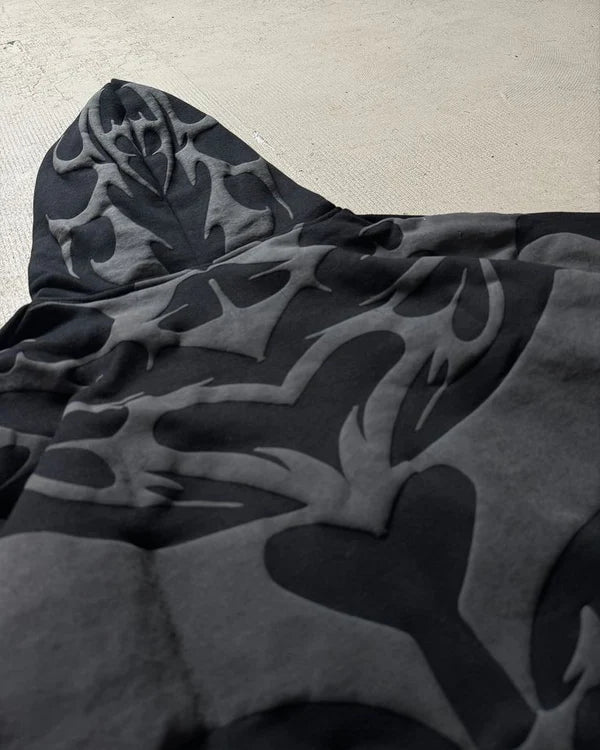 Black and gray flame-patterned hoodie on a light gray background