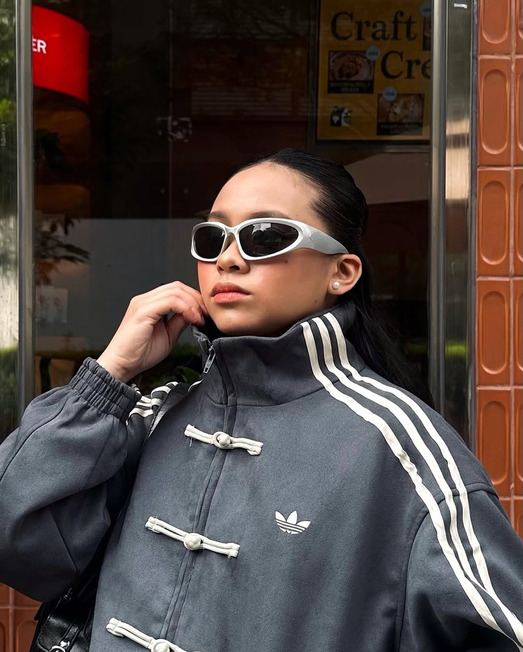 Lifestyle portrait of the female model in the stealth Dark Grey variant. The muted tone and thick traditional knot closures cement this piece as an ultimate genderless darkwear grail for women's streetwear fashion in India.