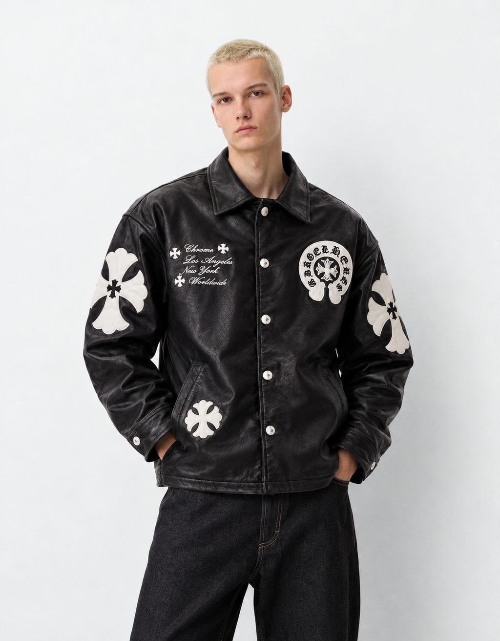 Male model wearing the stealth black Gothic cross patch faux leather jacket, showcasing the monochrome dark luxury aesthetic.