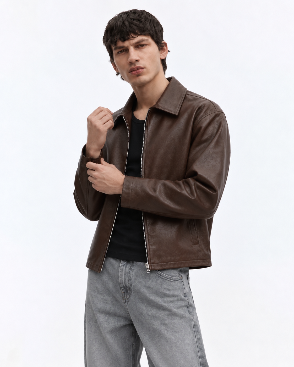 Back and side profile of the boy wearing the Streetbred cropped leather jacket, emphasizing the baggy Gen-Z streetwear fit