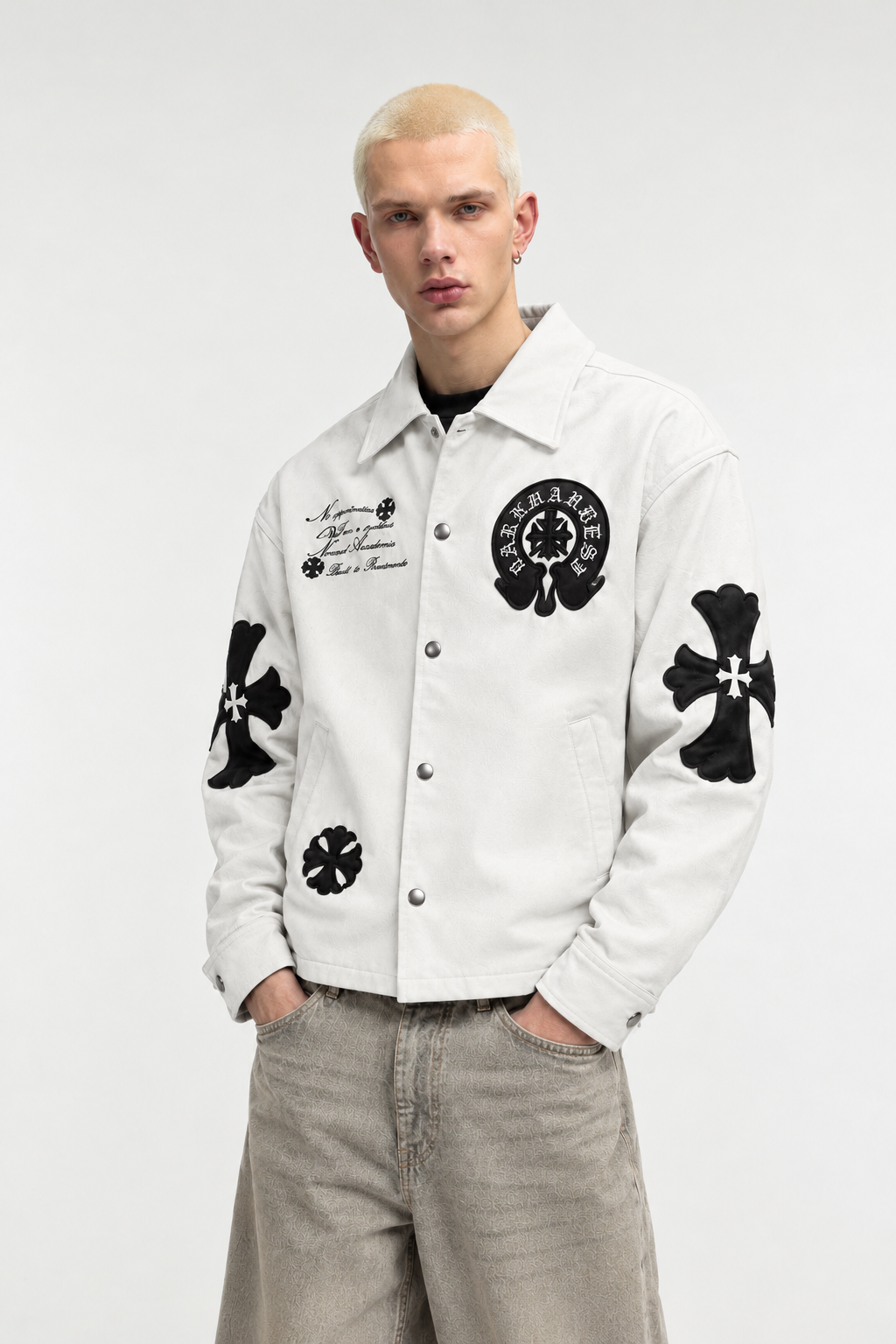 Streetwear styling of the off-white faux leather jacket on a male model paired with loose cargo pants, demonstrating the relaxed drop-shoulder cut