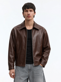 Male model wearing the Streetbred unisex brown boxy leather jacket, highlighting the cropped waist and oversized drop shoulders