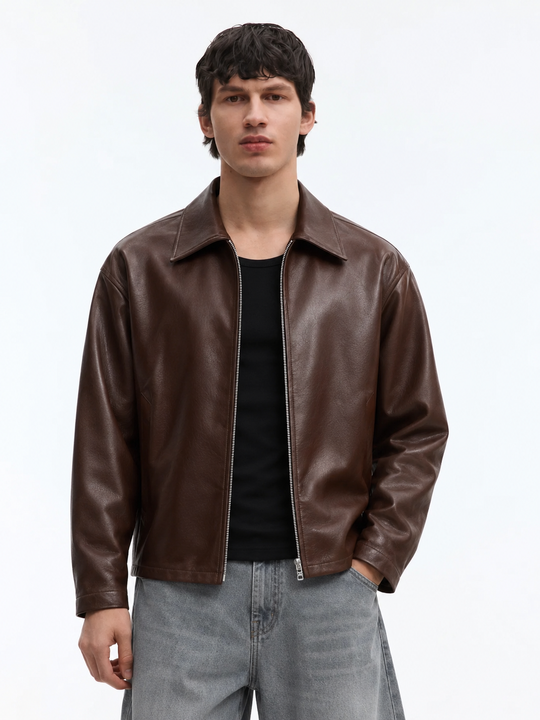 Male model wearing the Streetbred unisex brown boxy leather jacket, highlighting the cropped waist and oversized drop shoulders