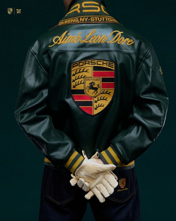 Model fully styled in the premium green vintage Formula 1 leather jacket. Highlights the luxury ALD aesthetic and the comfortable, boxy Y2K racing leather fit designed exclusively for high-end winter motorsports clothing in India.