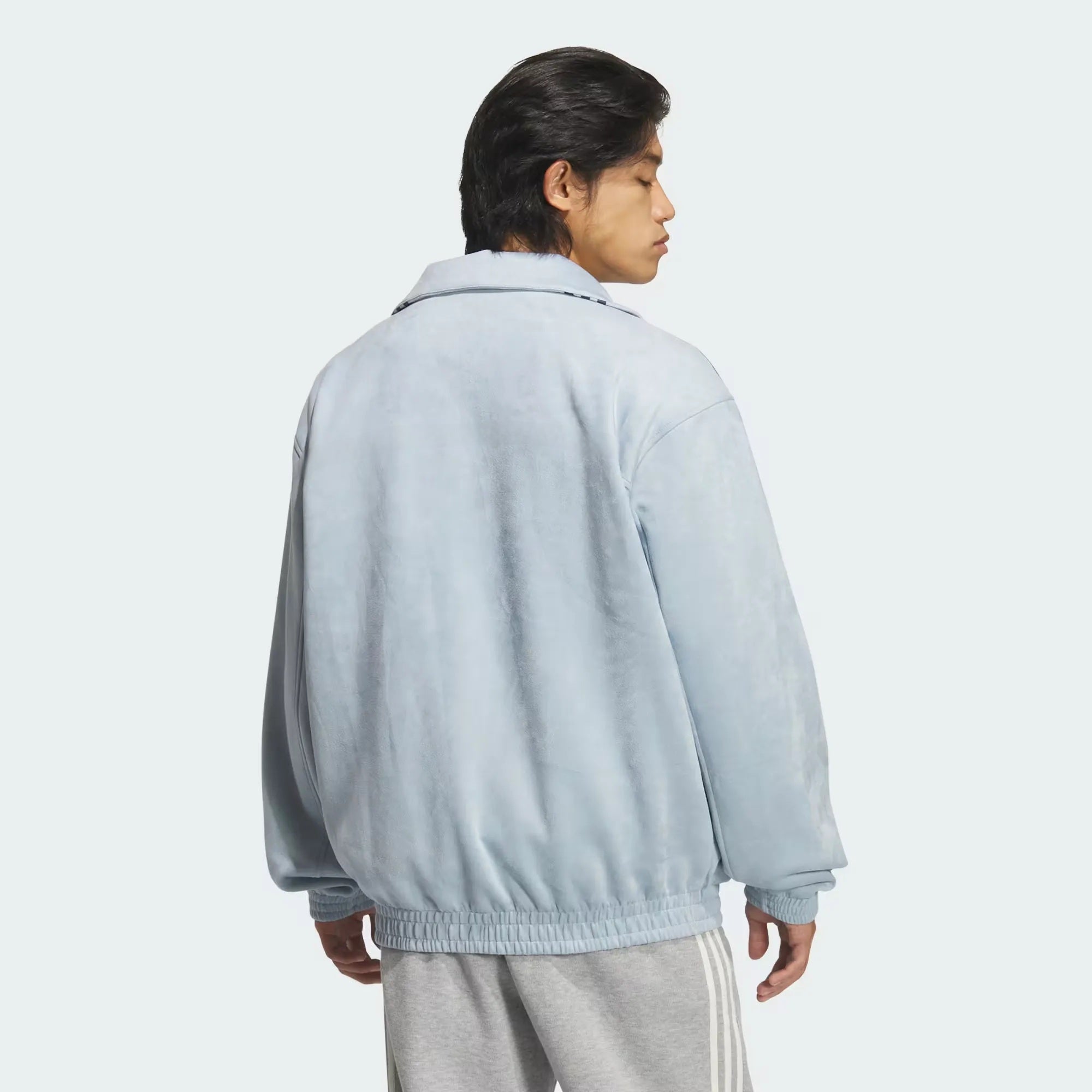 Model wearing the drop-shoulder boxy fit sky blue Adidas CNY knot jacket