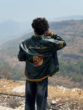 Back view showing massive gold Porsche embroidery on green F1 bomber jacket unisex