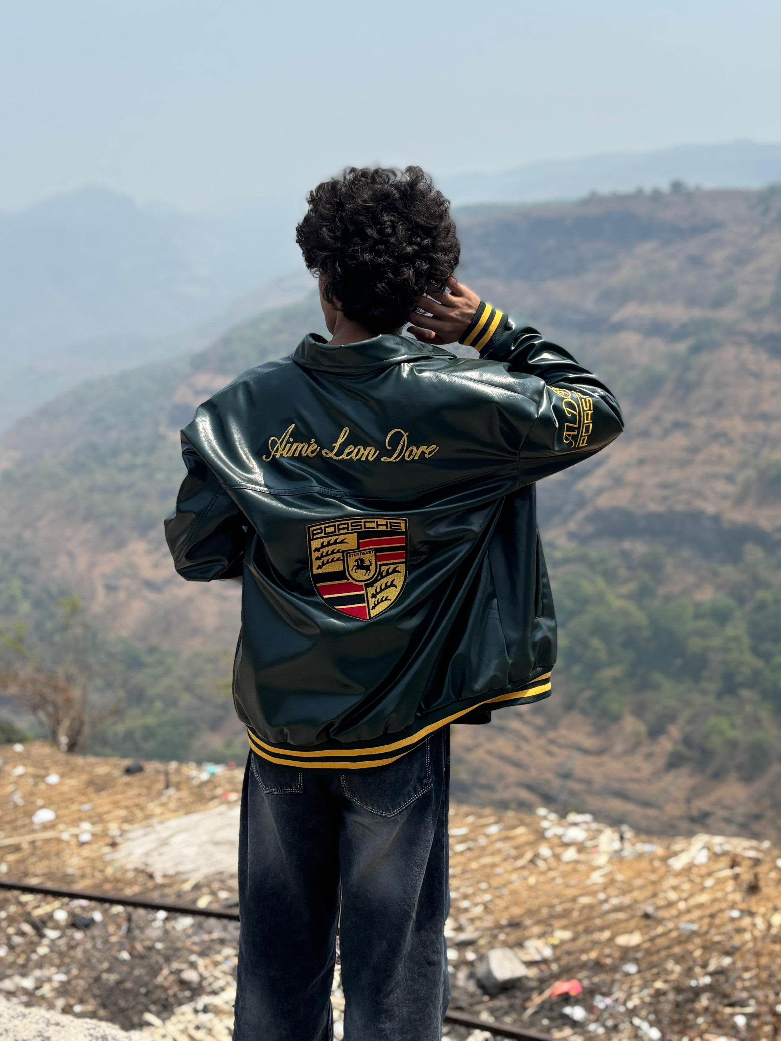 Back view showing massive gold Porsche embroidery on green F1 bomber jacket unisex