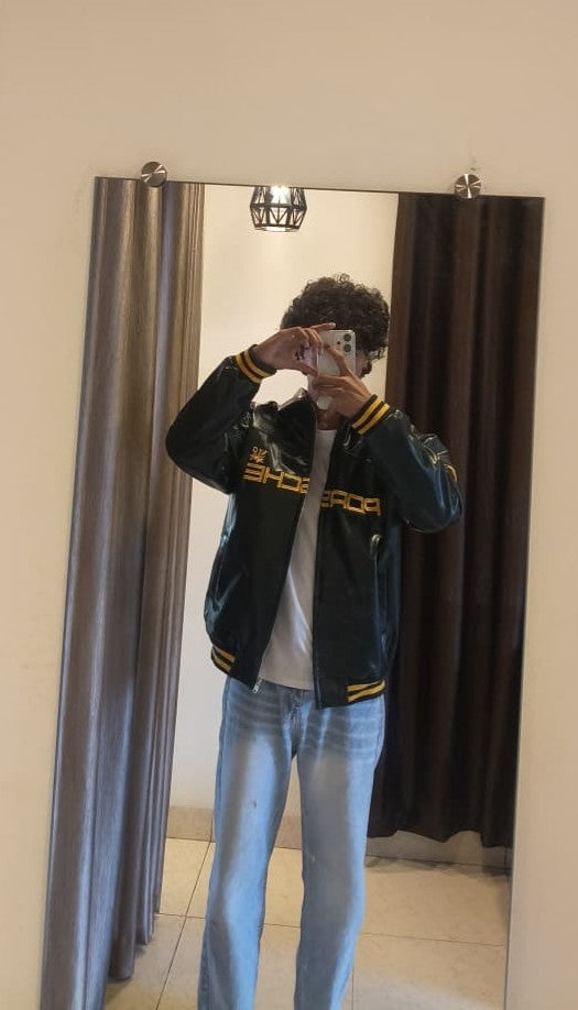 Front view of oversized green vintage Porsche 993 racing leather jacket streetwear India
