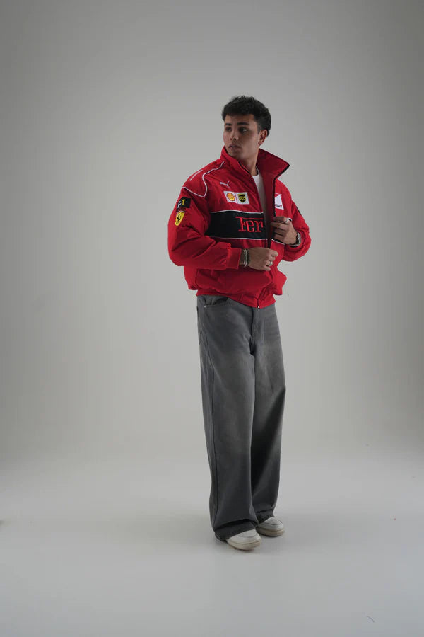 Side Profile of Red Ferrari F1 Jacket Highlighting Sleeve Patches and Oversized Fit