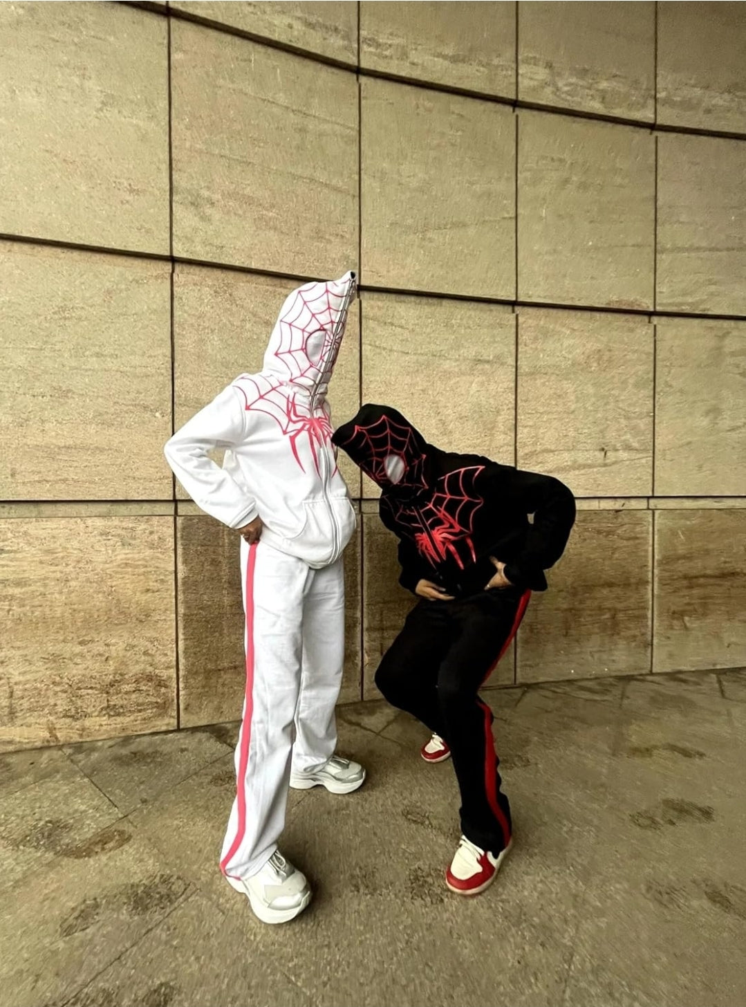 Lifestyle Streetwear Shot of matching White and Black Spiderman Zip-Up Hoodies

