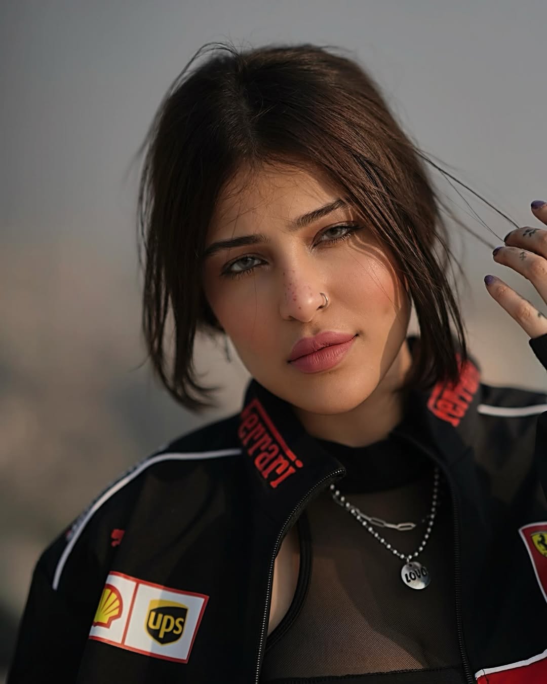 Lifestyle outdoor shot of a woman in the city styling the Streetbred Black Ferrari F1 Jacket.