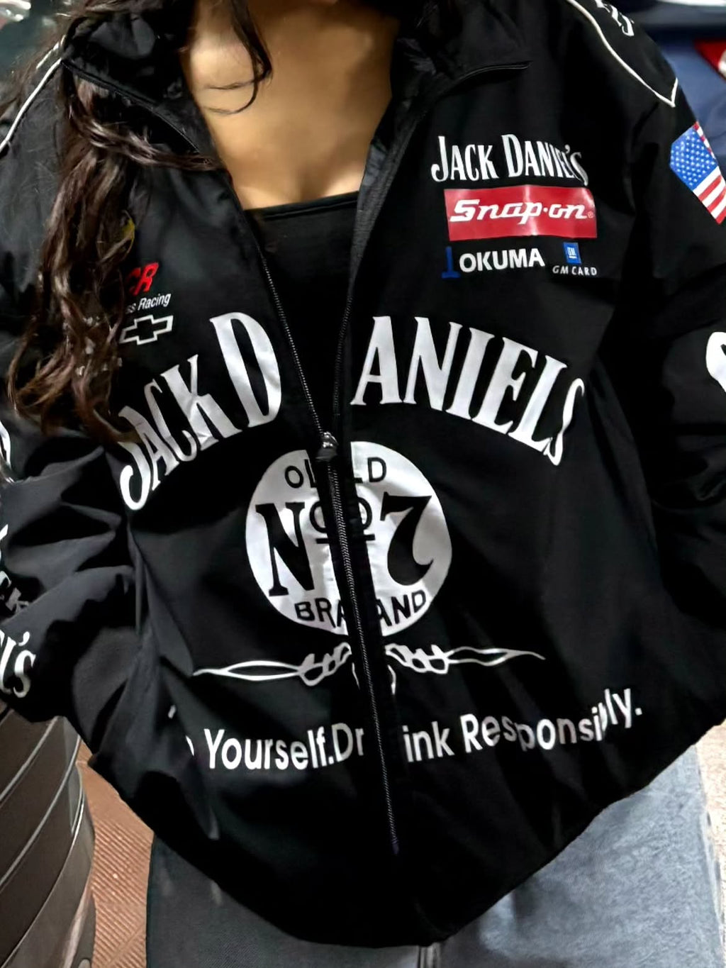 Female model wearing the oversized vintage Jack Daniel's racing jacket by Streetbred
