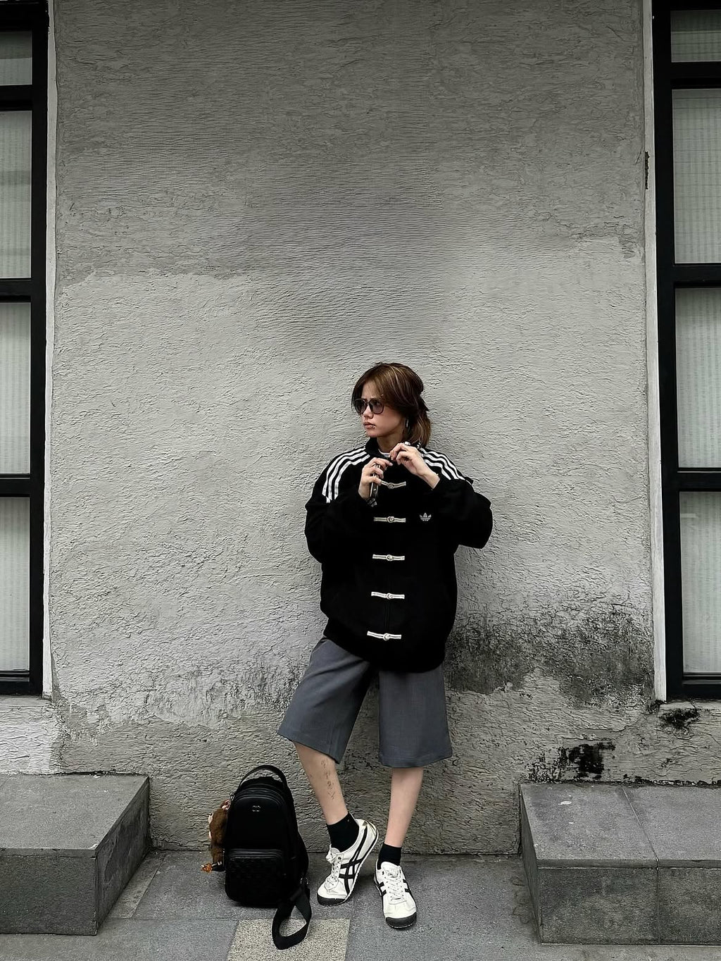 Woman wearing the Unisex Black CNY Adidas Knot Jacket by Streetbred, highlighting the Korean oversized streetwear drape and traditional frog buttons.
