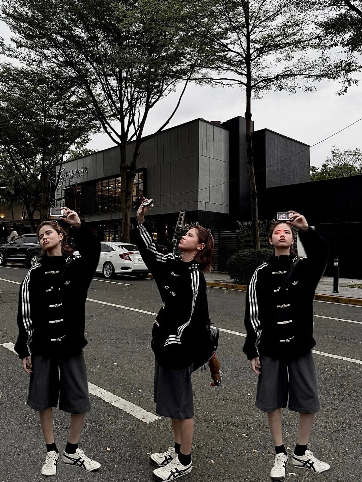 Streetwear look featuring a woman in the deep black Lunar New Year Adidas jacket, displaying the aesthetic sleeve stripes