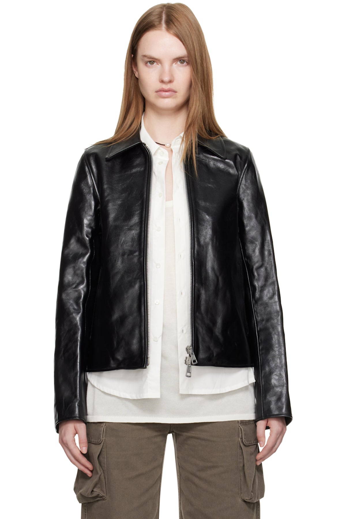 Female model styling the Black Cropped Faux Leather Jacket, showcasing the unique textured finish and aesthetic sleeve zips