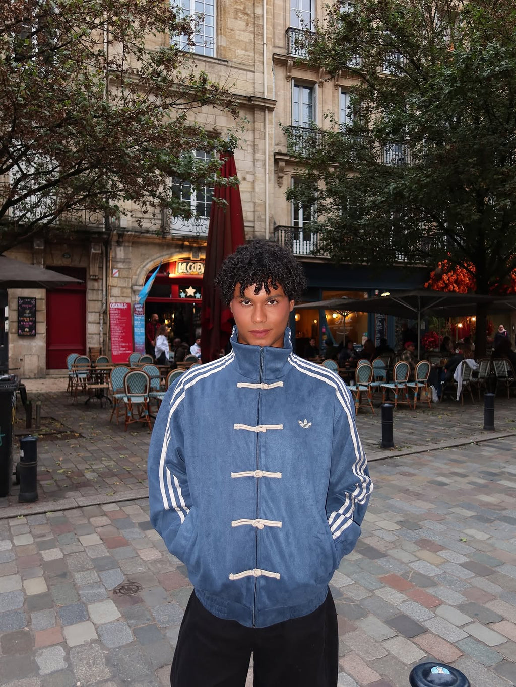Man wearing the Unisex Navy Blue CNY Adidas Jacket, highlighting the versatile boxy fit perfect for layering in winter streetwear.
