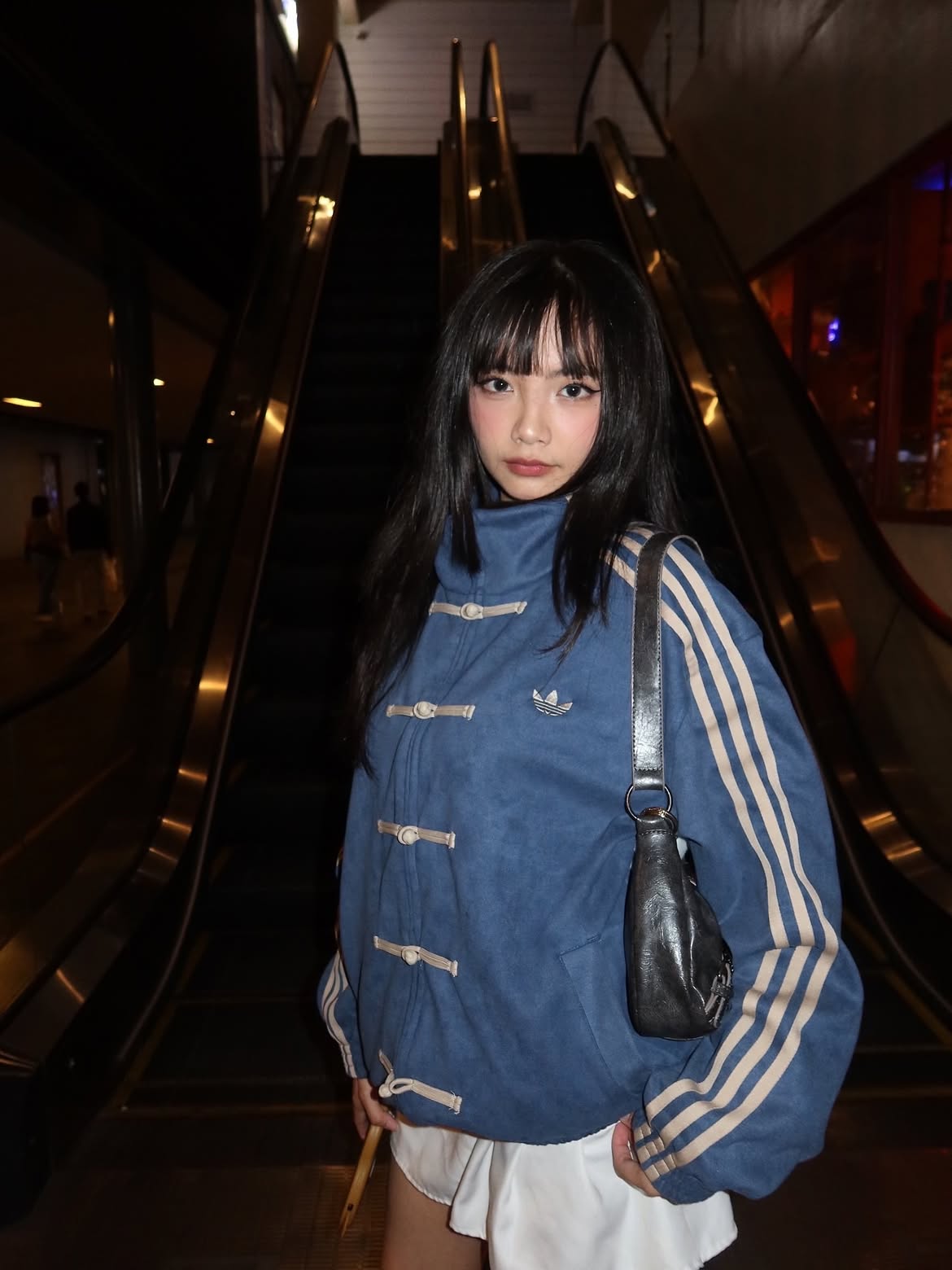 Woman styling the Unisex Navy Blue CNY Adidas Jacket by Streetbred, demonstrating the modern slightly cropped boxy fit and traditional knot closure.