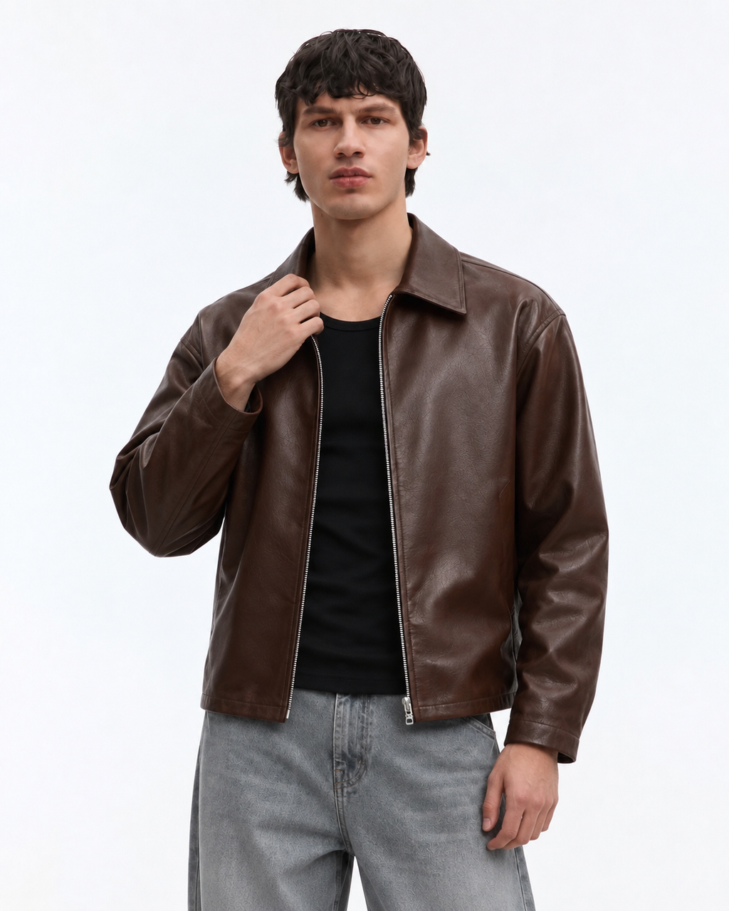 Close up of a boy styling the PU faux leather streetwear jacket, focusing on the heavy-duty front zip and functional kangaroo pockets