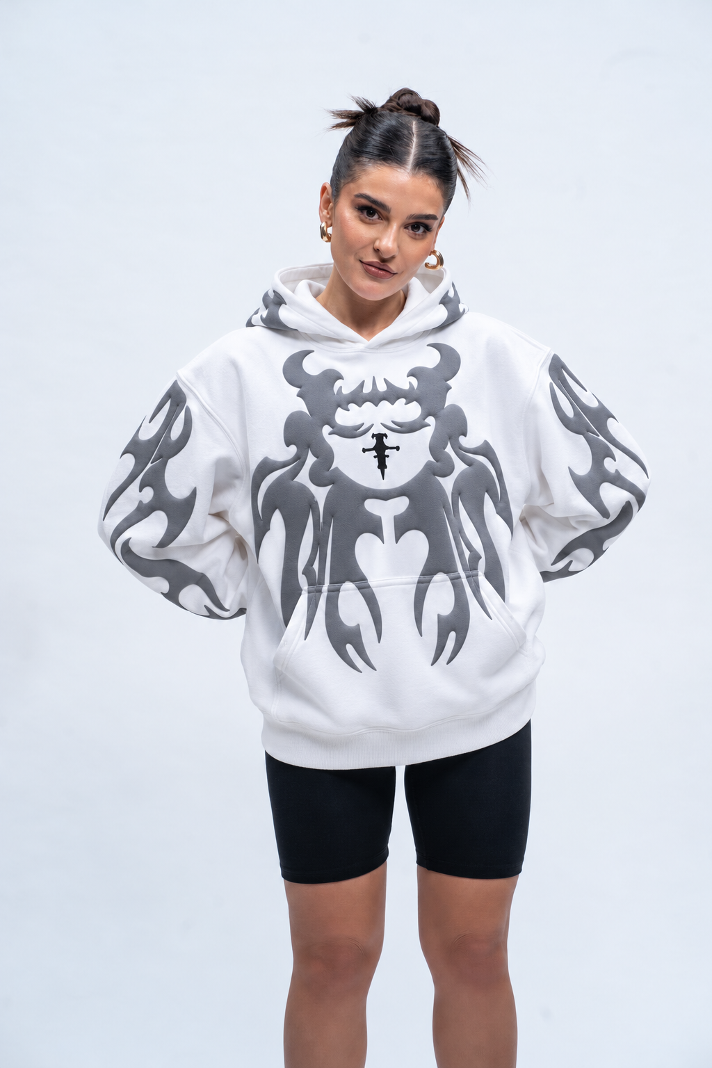 Lifestyle shot of the girl in the white oversized depth hoodie, highlighting the stringless hood and cozy streetwear fit