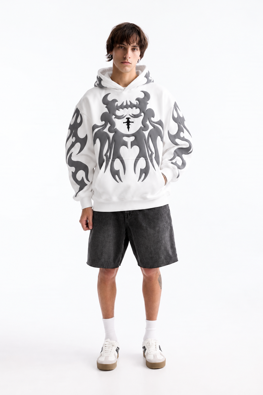 Streetwear styling of the white loosefit hoodie on a male model, contrasting the dark puff print graphics against the bright fleece