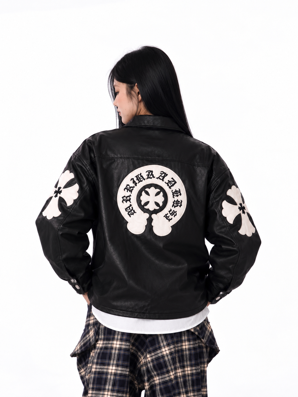 Back view of a girl wearing the black Gothic cross leather jacket, highlighting the large rear horseshoe emblem and sleeve cross details