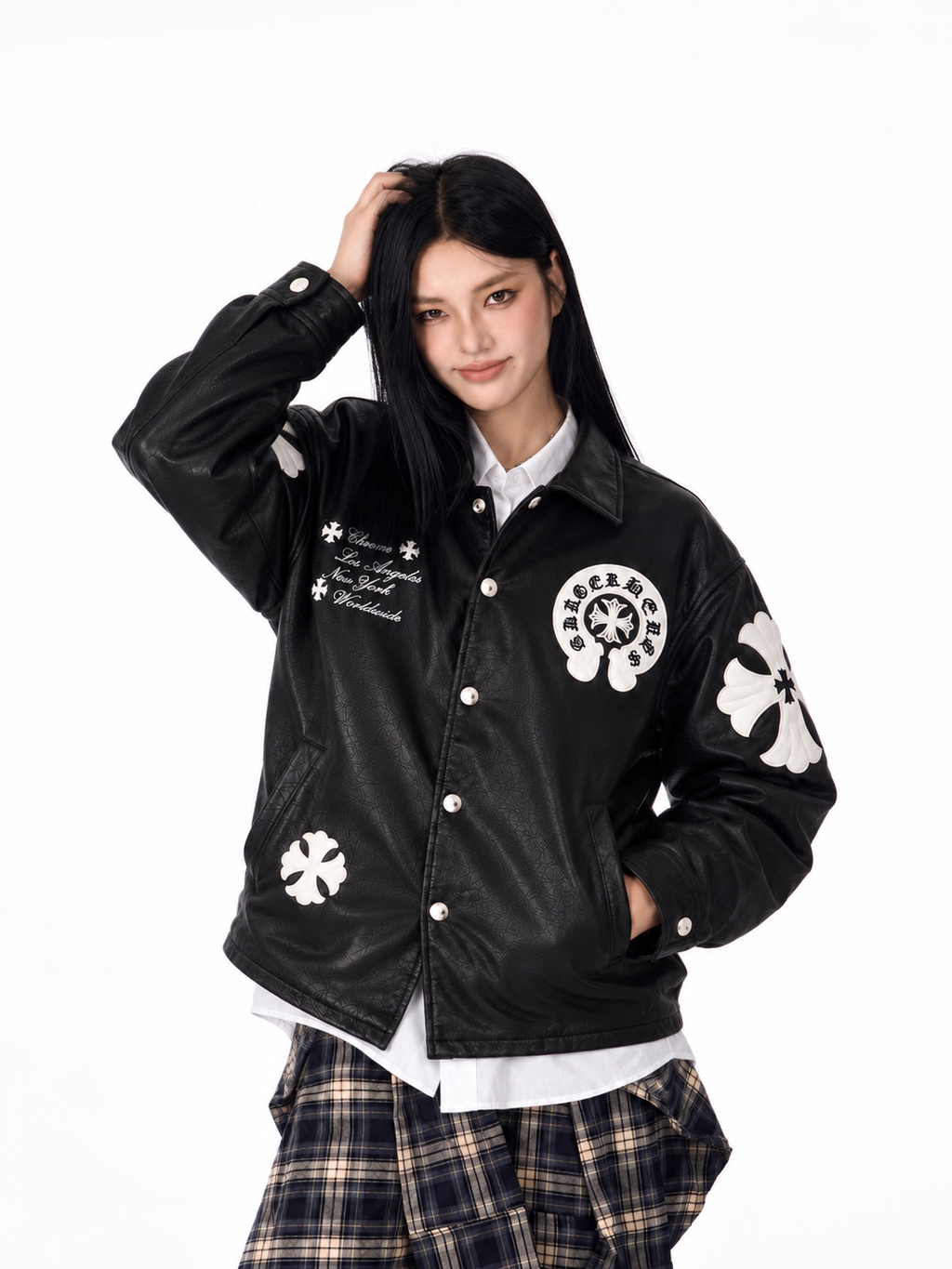 Female model wearing the unisex black Gothic cross patch leather jacket from the front, demonstrating the structured drop-shoulder drape