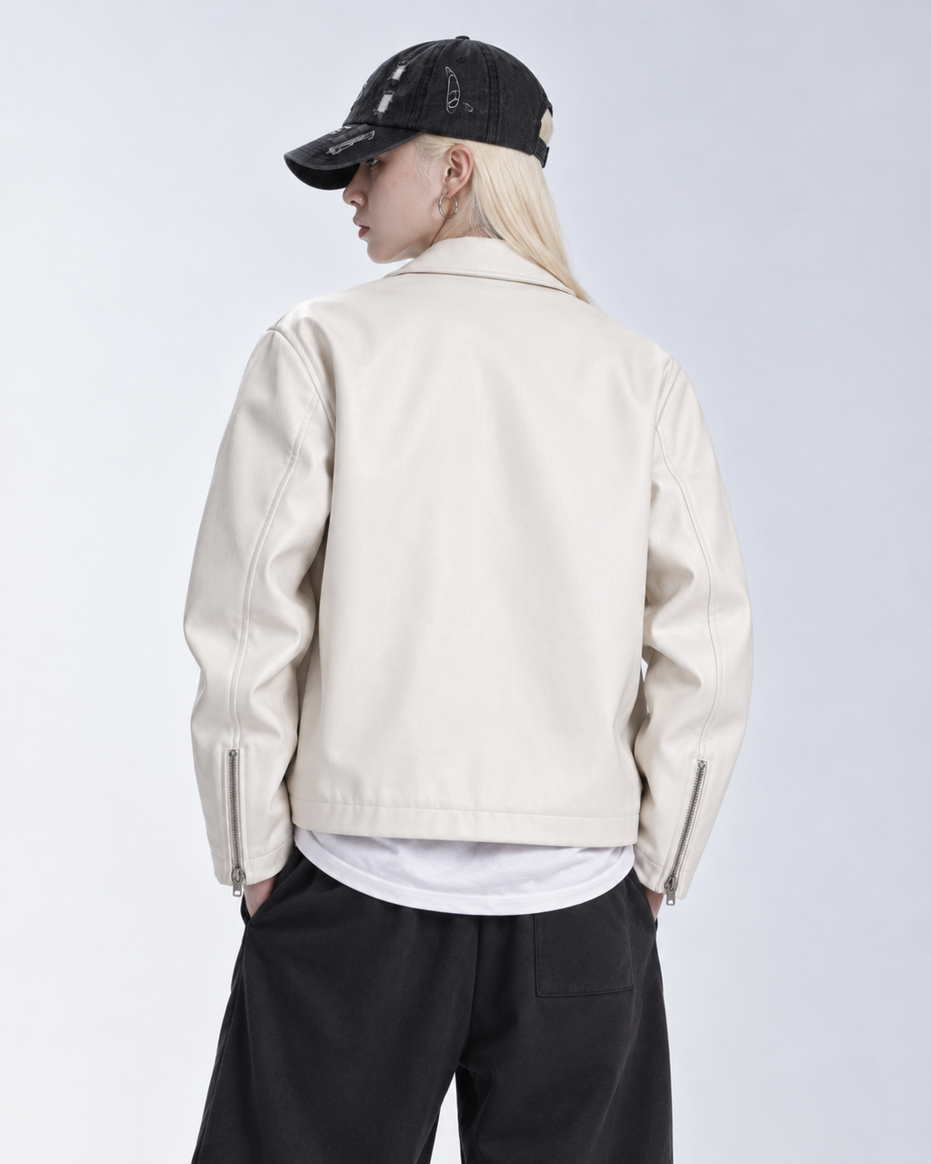 Side and back view of the female model wearing the boxy cropped jacket, highlighting the smooth anti-static polyester interior and baggy aesthetic