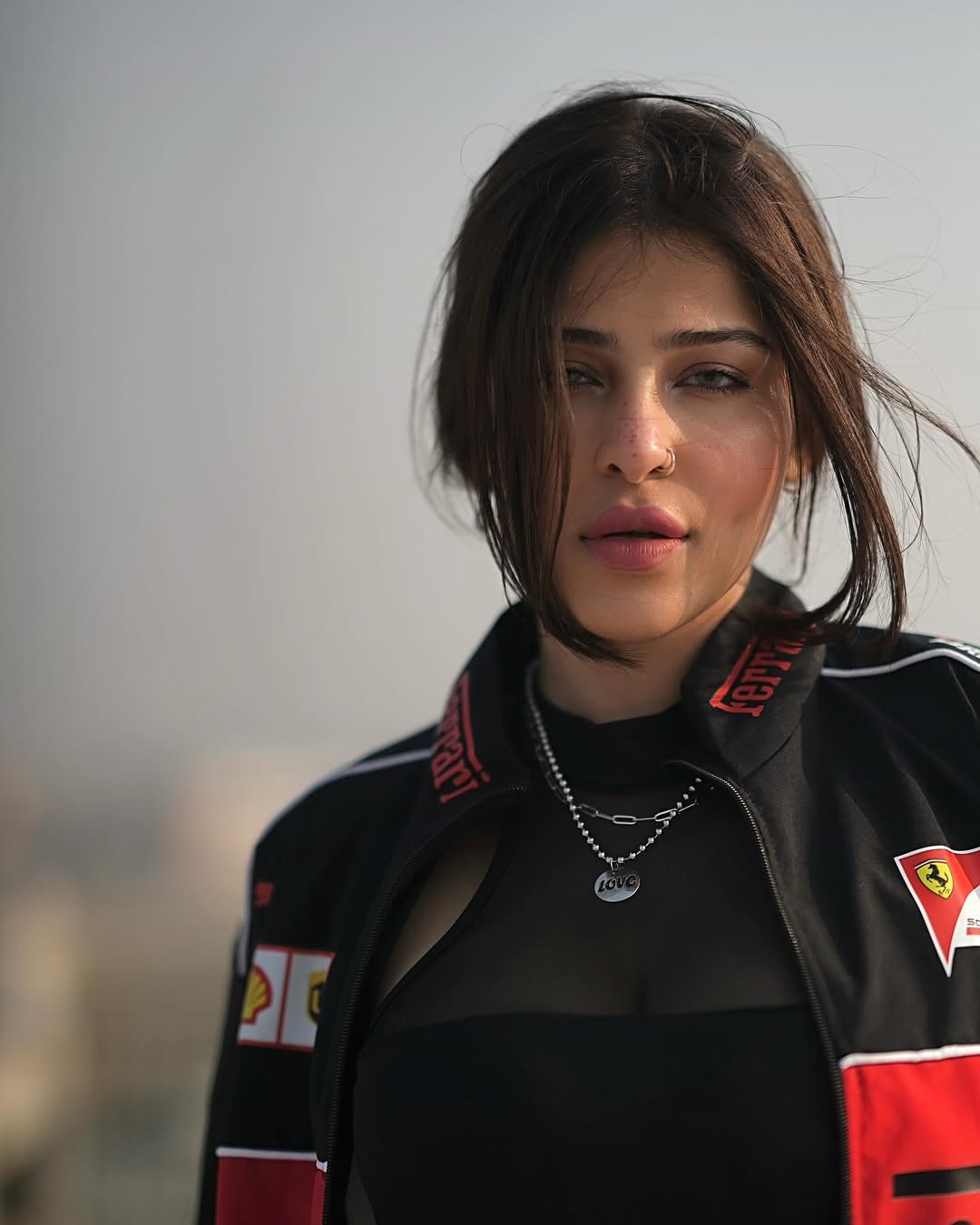 Close-up of a woman wearing the premium heavyweight Streetbred Black Ferrari F1 Jacket highlighting the 3D details.