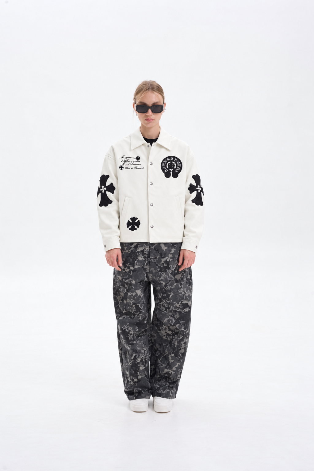 Full length fashion shot of a female model wearing the off-white cross patch leather jacket, showcasing the modern Y2K dark luxury silhouette