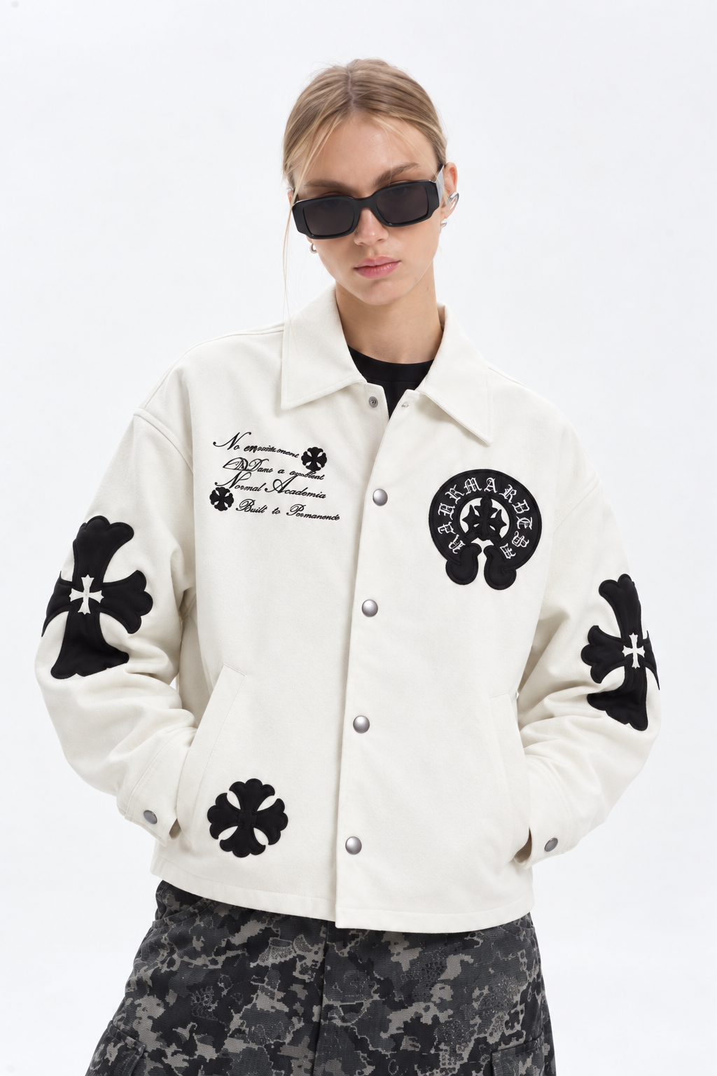 Female model wearing the unisex off-white Gothic cross patch faux leather jacket, highlighting the tailored boxy trucker fit