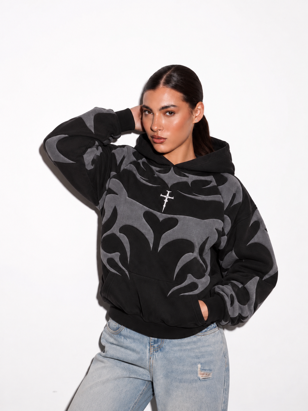 Female model styling the unisex oversized black depth hoodie, showcasing the thick 400 GSM fleece streetwear aesthetic.