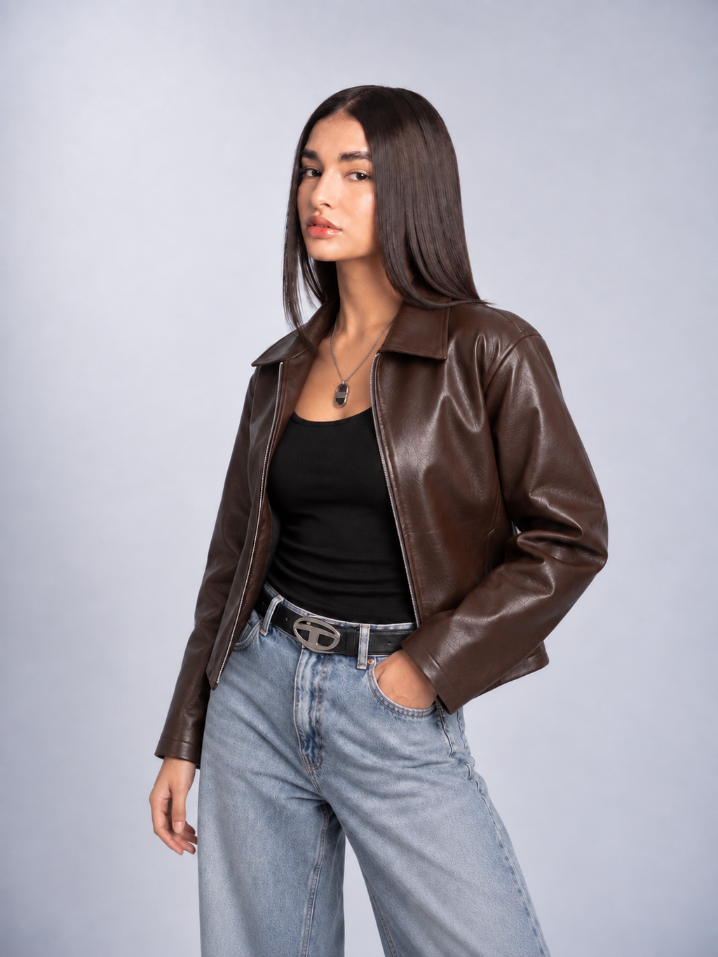 Front open styling of the female model wearing the boxy collared leather jacket, demonstrating the frictionless polyester lining