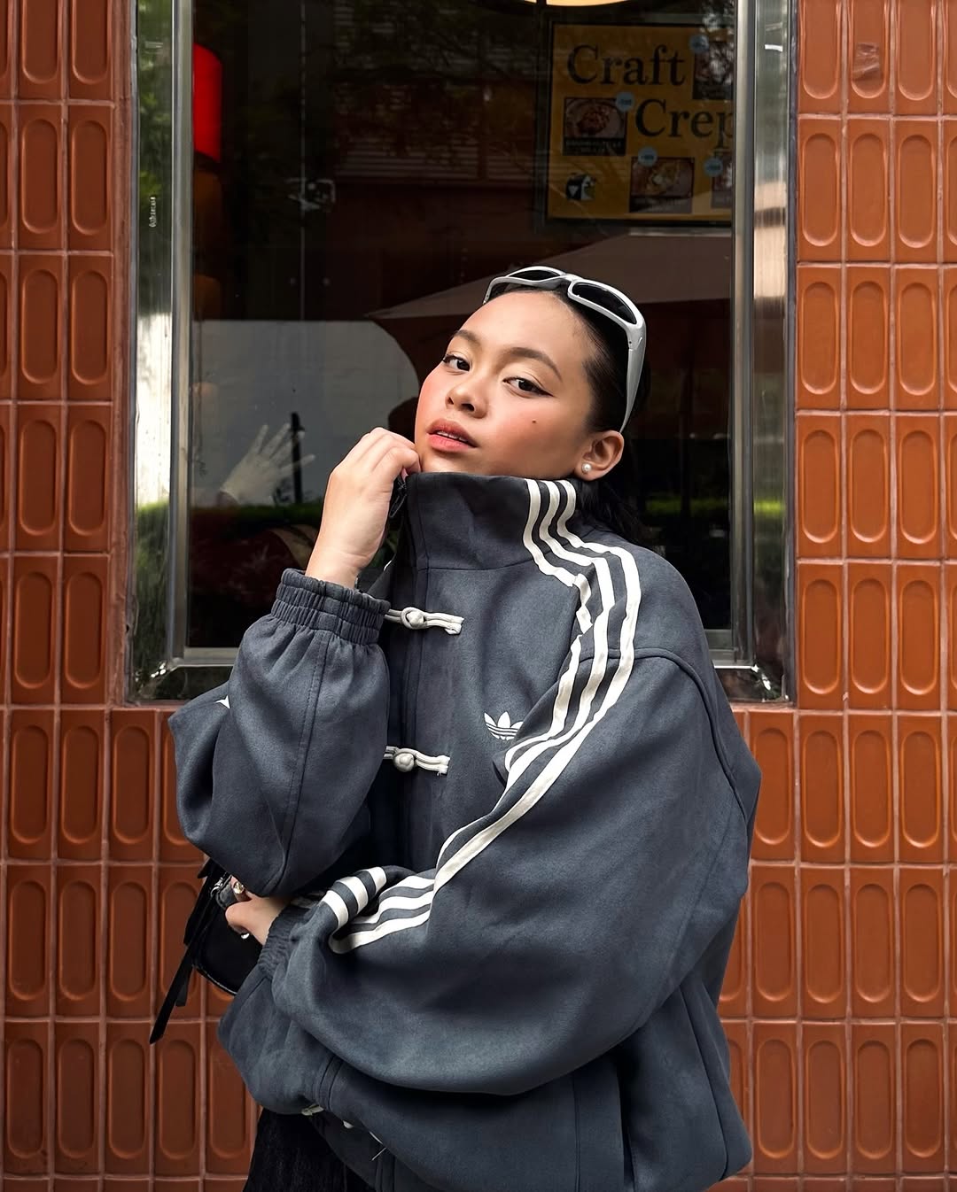 Frontal shot of the female model wearing the Dark Grey CNY Knot Jacket. Perfectly executes the highly sought-after "model off-duty" look by combining the ultra-oversized mens-cut suede bomber over tight streetwear base layers.