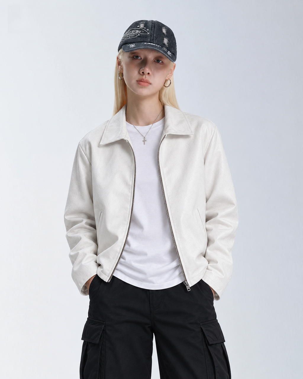 Female model styling the unisex Streetbred white leather jacket, showcasing the effortless oversized streetwear silhouette